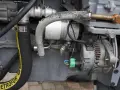 Fragment pompy hydraulicznej Ursus C-360 z przewodami i alternatorem.