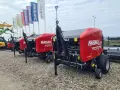 Rzędy czerwonych pras rolujących Mascar, gotowych do pracy na polu.