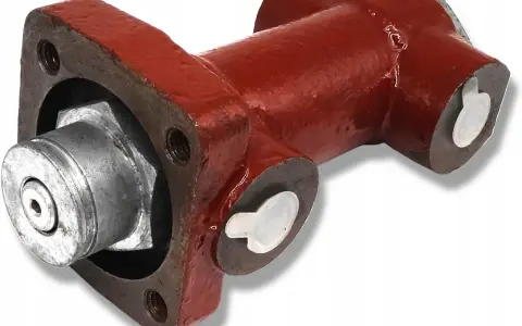Część hamulca ciągnika Zetor: metalowy element z czerwonym korpusem i srebrnymi zaślepkami.