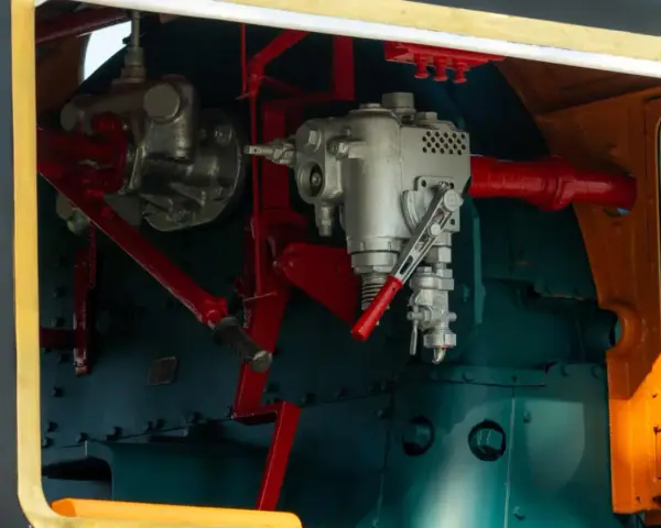 Mechanizm sterowania lokomotywy, z widocznymi elementami hydraulicznymi. Może to być oznaka awarii hydraulicznej, wymagającej naprawy.
