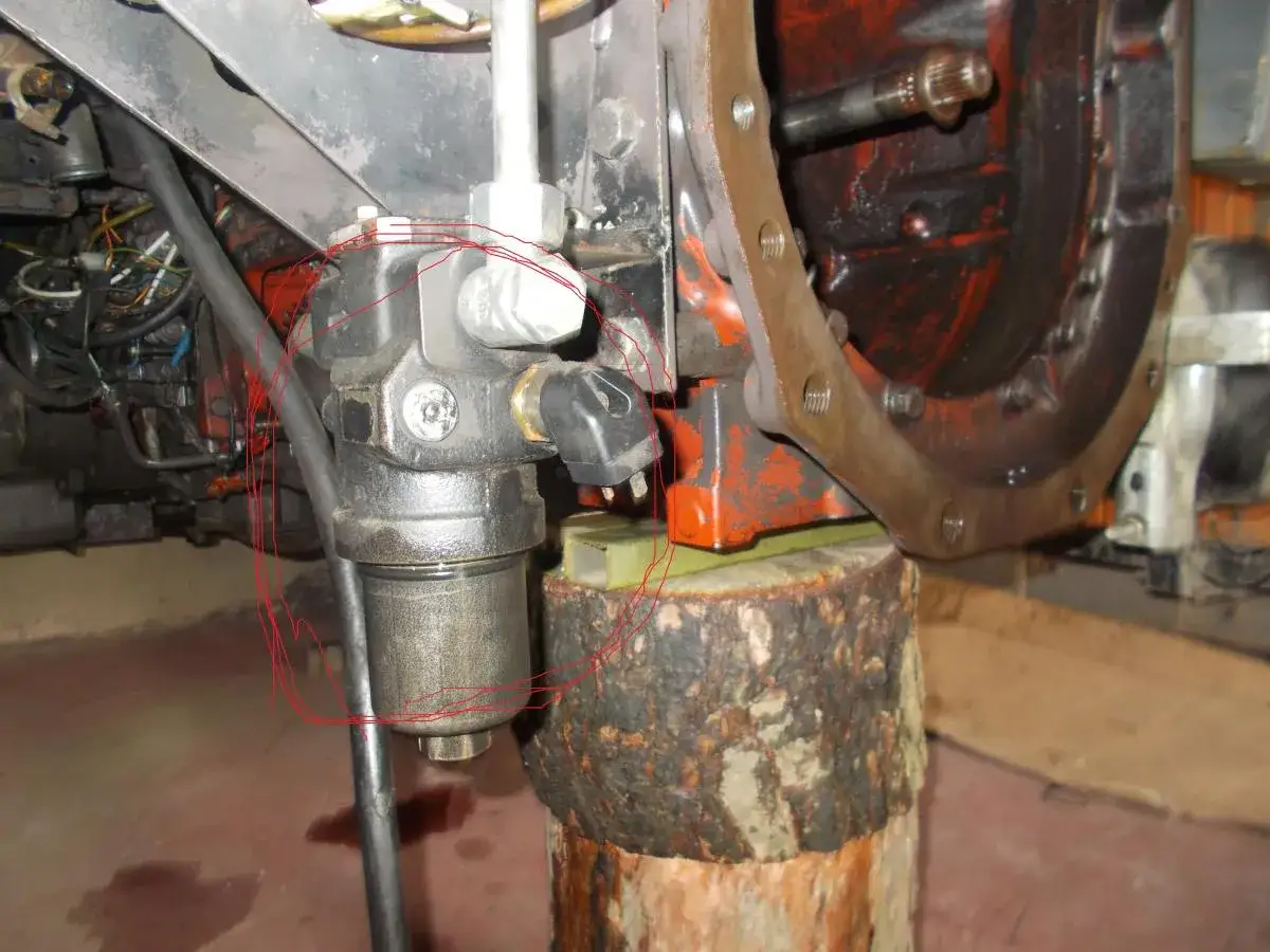 Wymiana pompy hydraulicznej MF 3080. Widoczny element układu hydraulicznego, przygotowany do demontażu.